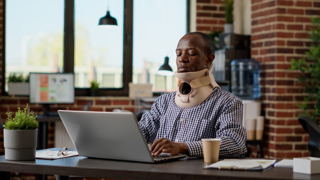 man with neck brace injury consulting a texas personal injury attorney online